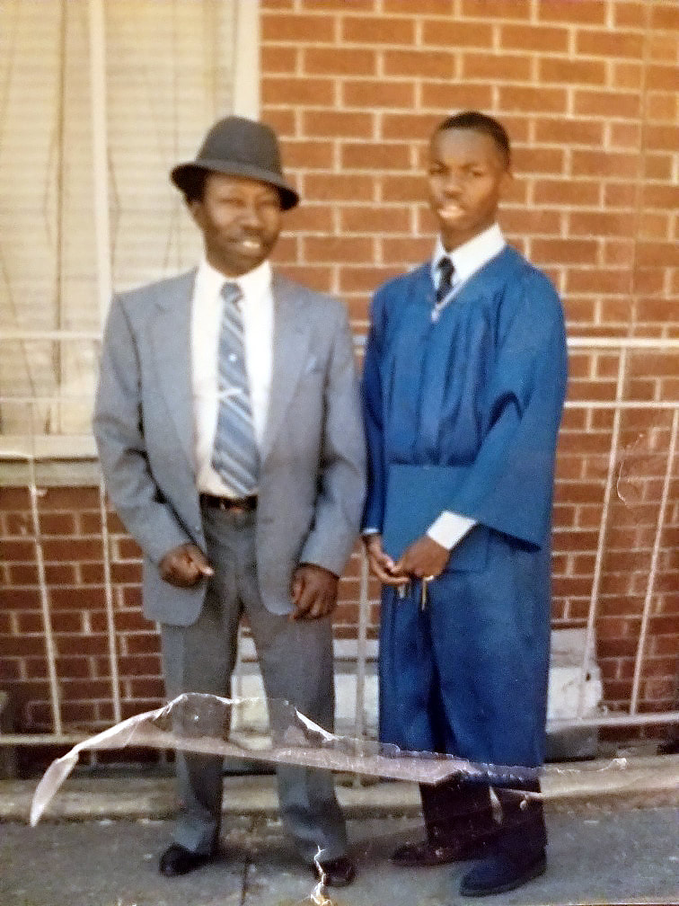 Emery Dickerson with his father at middle school graduation.